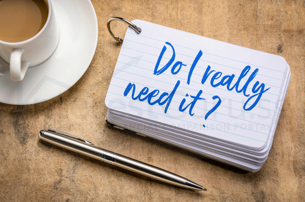 A notepad with words Do I really need it and a cup of coffe on a table